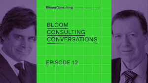 Promotional graphic for "Bloom Consulting Conversations" podcast featuring portraits of Jose Filipe Torres and Dr. Keith Dinnie from Bloom Consulting, with a green grid background and bold text highlighting the podcast title.